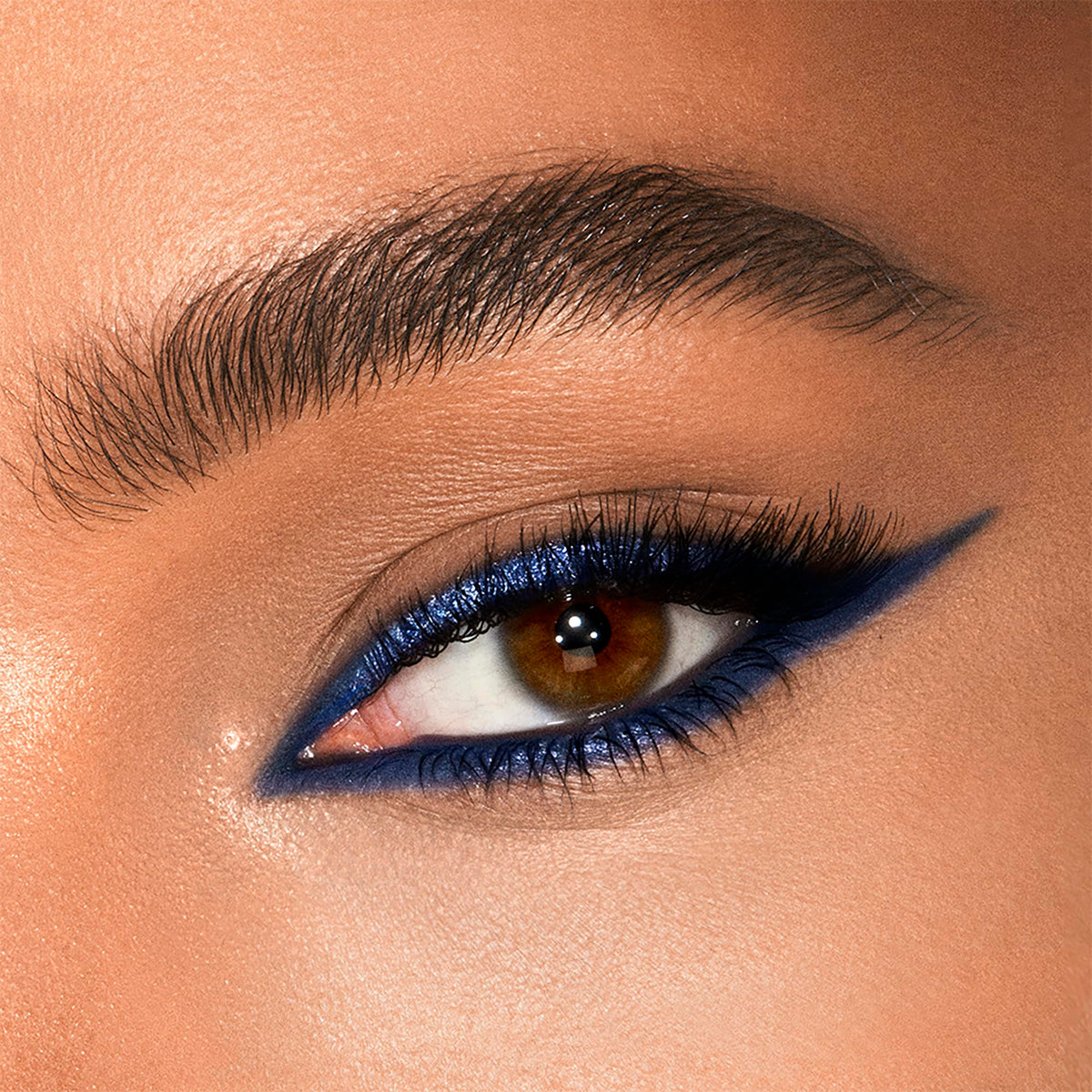 Charlotte Tilbury swatch strokes of matte and metallic on skin showing blendable formula benefit