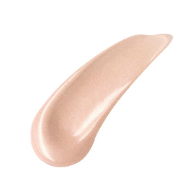 Charlotte Tilbury applying primer to cheekbone demonstrating instant luminous effect