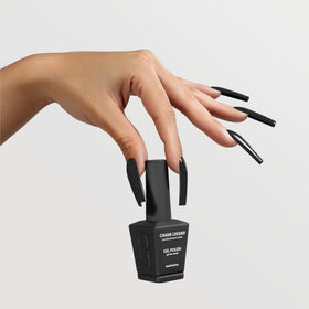 Chaun Legend nail swatches on color wheel showing opaque black coverage in one coat