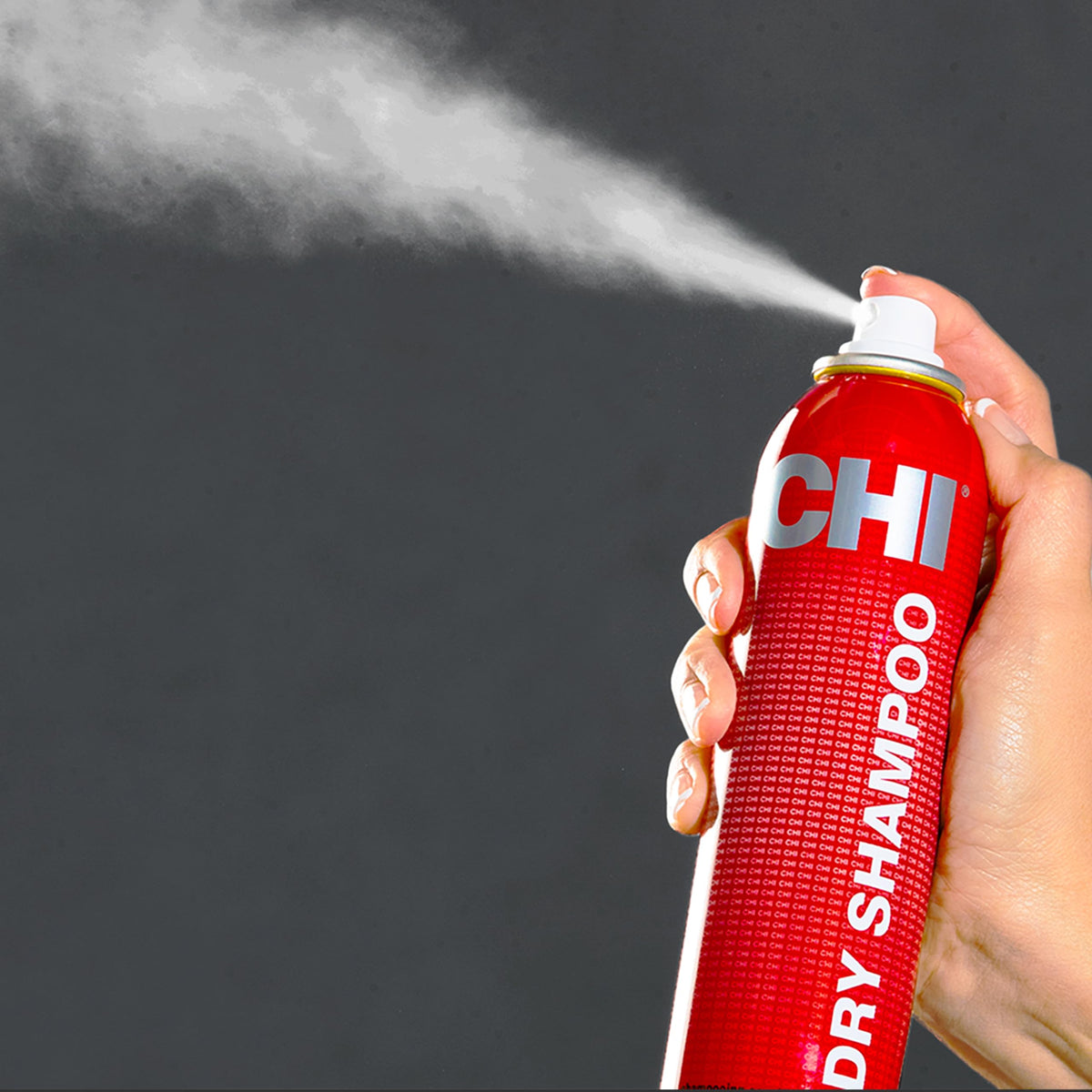 CHI dry shampoo being applied to roots in hand for oil absorption
