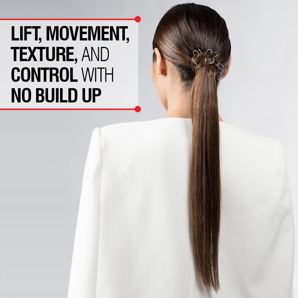 Model using CHI spray on curled hair to create defined movement and texture
