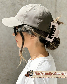 CHLINS in use with trucker hat showing high ponytail kept tidy and comfortable