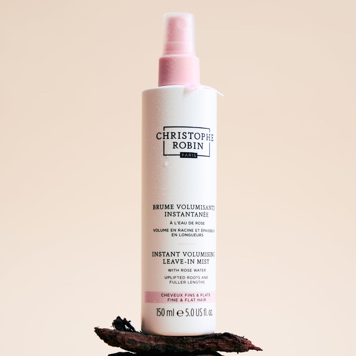 Christophe Robin bottle held in hand showing 5 fl oz travel-friendly size