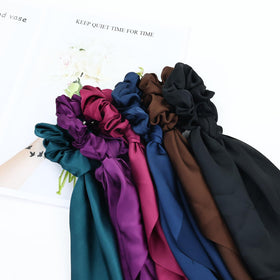 Cinaci lifestyle shot of woman wearing scrunchie adding a chic finishing touch to outfit
