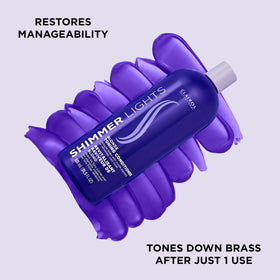 Clairol Professional conditioner poured to show creamy purple texture and hydration