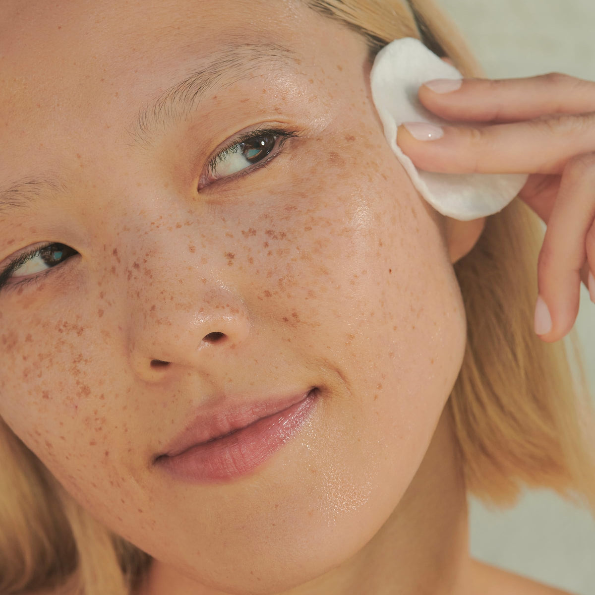 Clarins being applied with cotton pad to remove cleanser residue