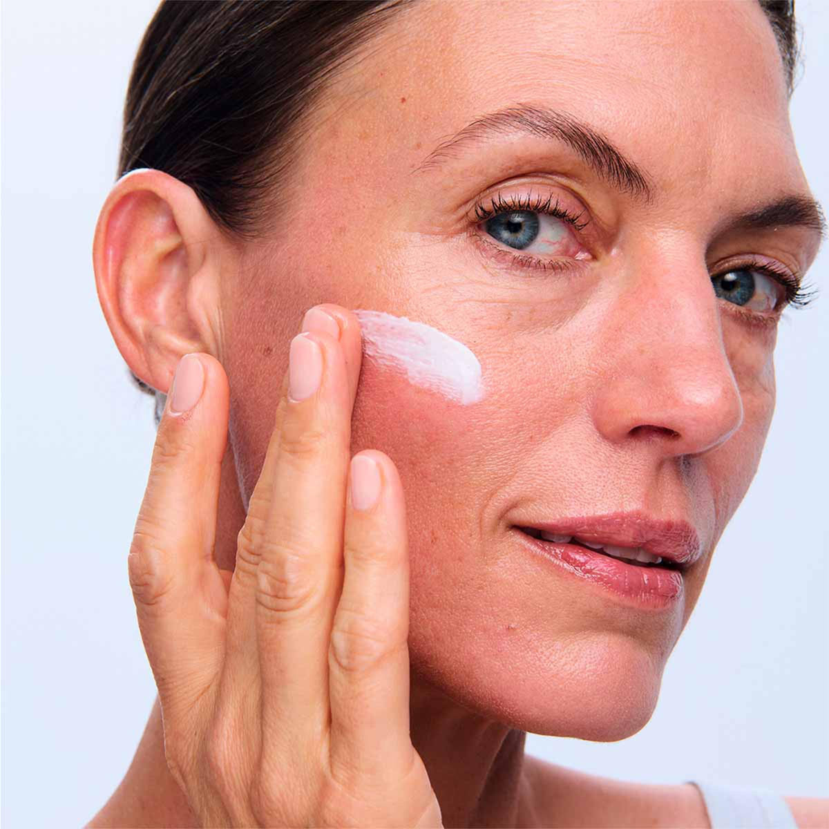 Clarins application on face illustrating morning use for smoother, illuminated skin