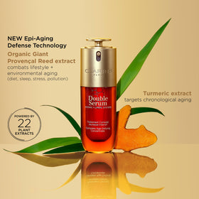 Clarins double serum next to a ruler illustrating 1 fl oz scale and travel-friendly size