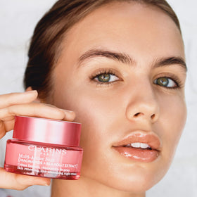 Clarins applied to model's face at night to show evening routine benefit