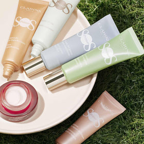 Clarins tube inside makeup bag suggesting portability and on-the-go prepping