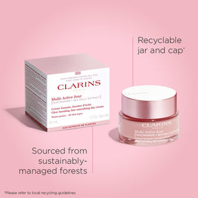 Clarins jar open with spoon swatch showing product color and even-tone benefit
