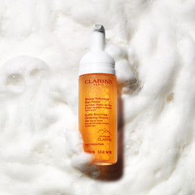 Clarins mousse beside ruler showing 5.5 oz size for travel and daily use