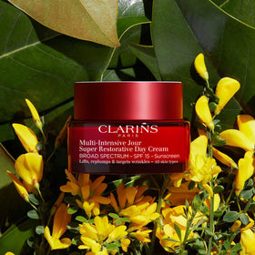 Clarins jar beside hand showing actual size and travel-friendly proportion benefit