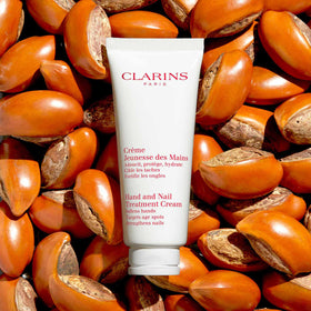 Clarins tube next to common objects for size comparison and portability