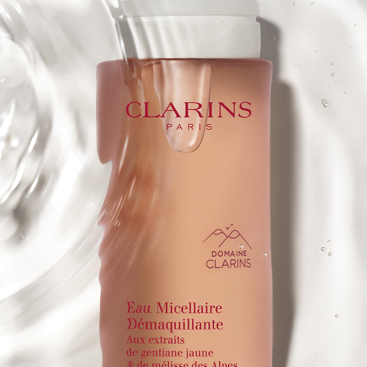 Clarins bottle held in hand for size comparison and travel-friendly convenience