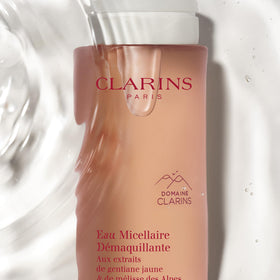 Clarins bottle held in hand for size comparison and travel-friendly convenience