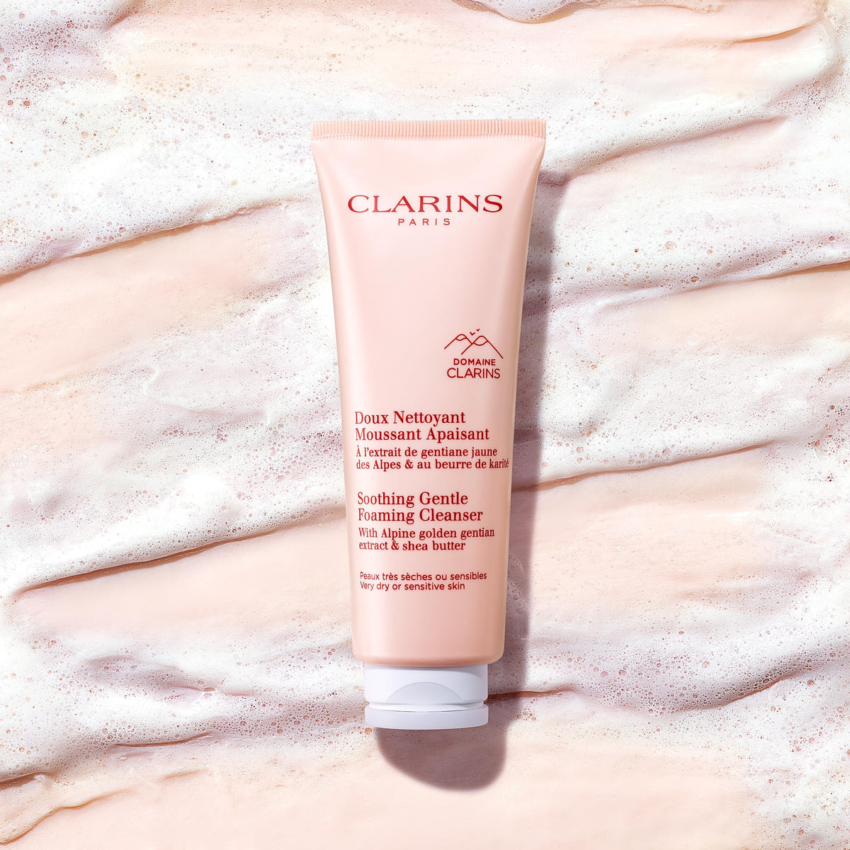Clarins size scale with 4.2 ounce bottle next to hand to show travel-friendly portion