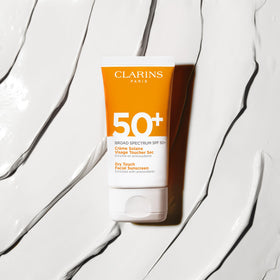 Clarins sunscreen layered under makeup showing compatibility and even foundation finish