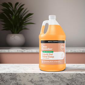 Clean Revolution being poured into a wall pump dispenser for quick refills