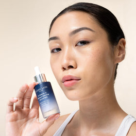 CLEAN SKIN CLUB bottle on vanity suggesting daily brightening ritual