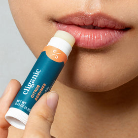 Cliganic balm in hand for scale showing pocket-friendly convenience