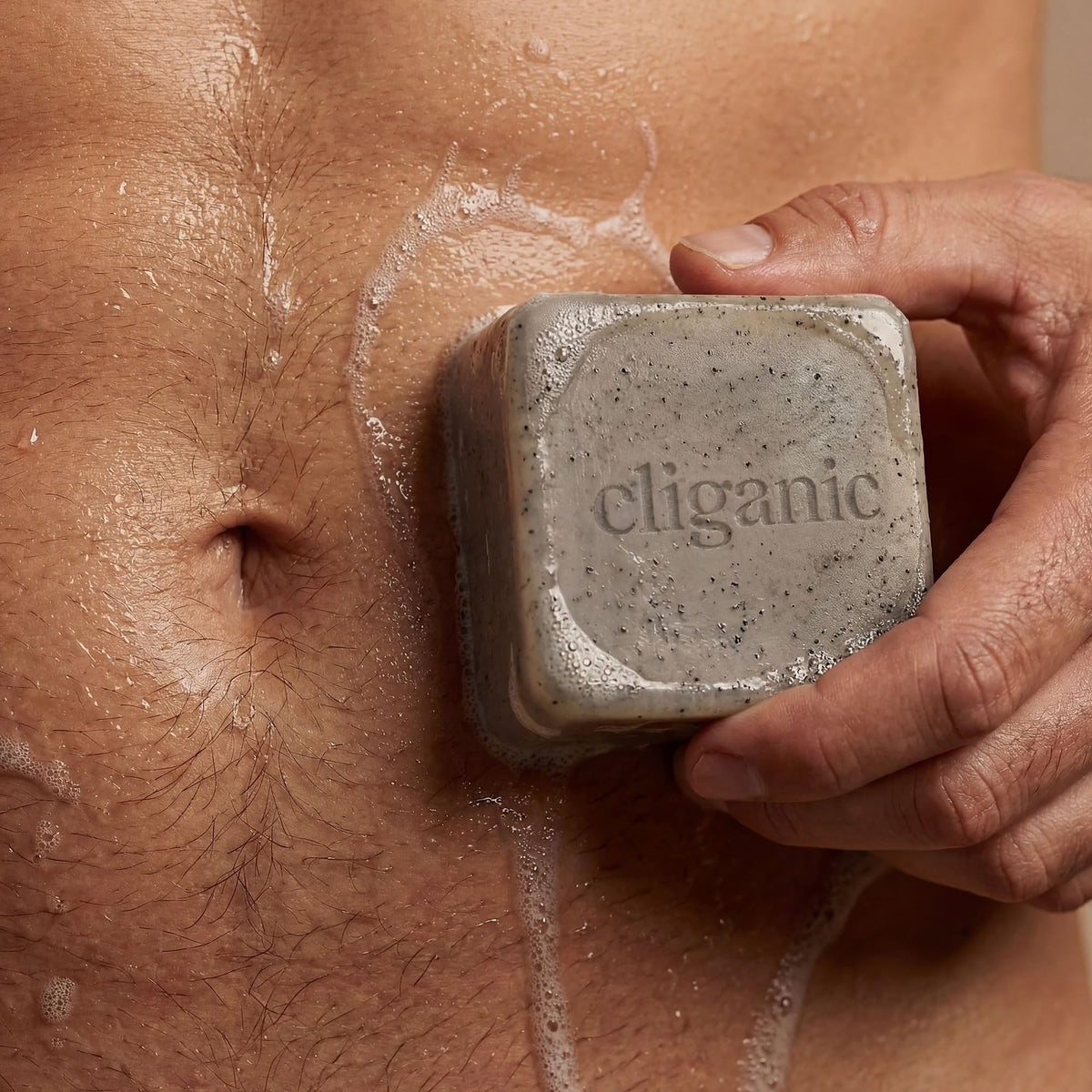 cliganic cypress neroli bar held in hand showing ergonomic shape and invigorating scent benefit