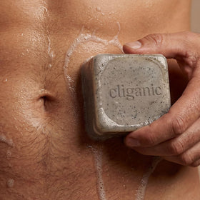 cliganic cypress neroli bar held in hand showing ergonomic shape and invigorating scent benefit