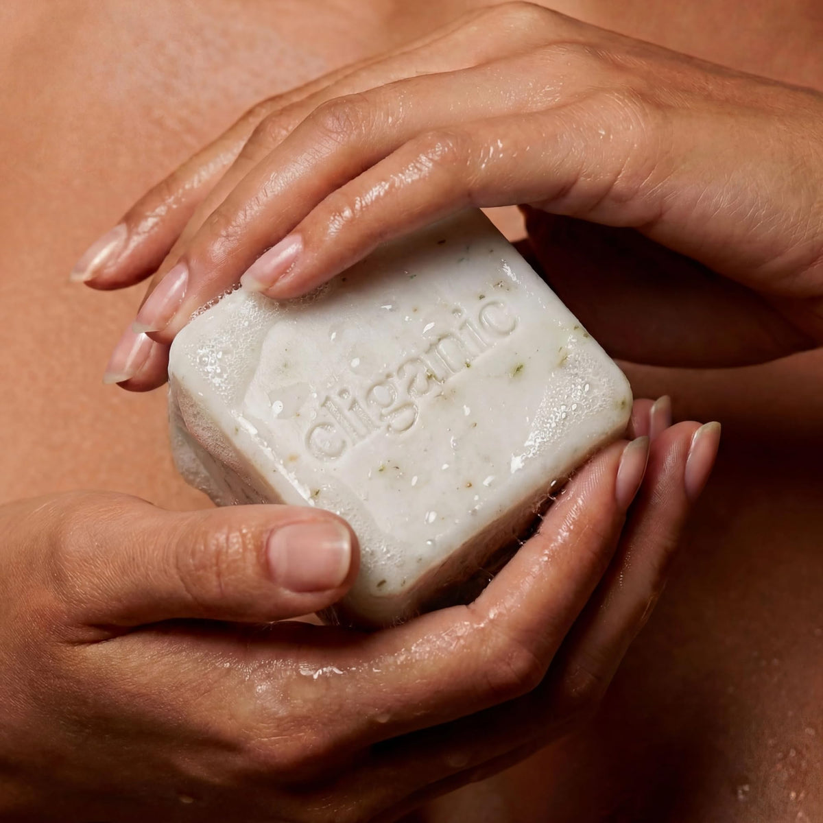 Cliganic vetiver jasmine bar being lathered emphasizing gentle cleanse benefit