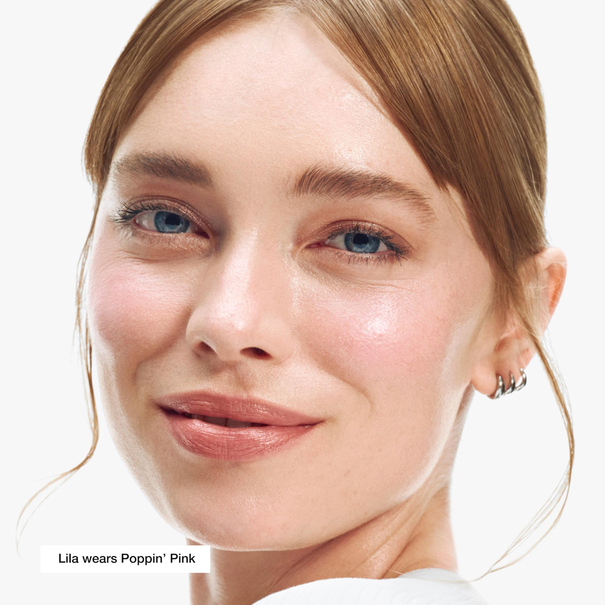 Clinique applying blush stick to cheek demonstrating quick no-mirror touch-up benefit