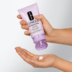 Person rinsing face with Clinique foaming wash demonstrating effective, non-drying cleanse