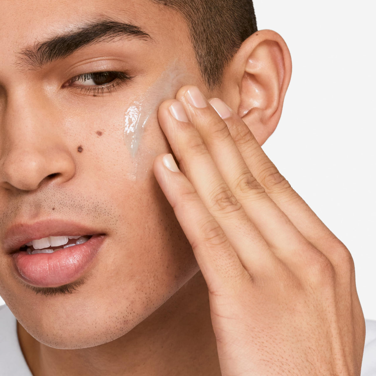 Clinique product held in hand to show compact 1.7 ounce travel-friendly size