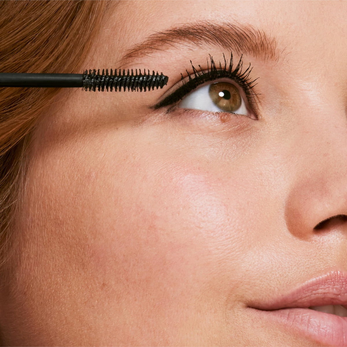 Clinique mascara placed inside a makeup bag illustrating travel ready waterproof performance