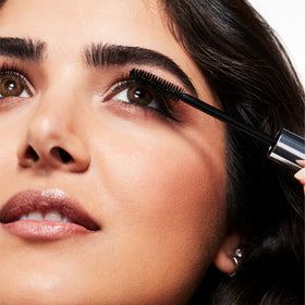 Clinique mascara next to ruler showing 1 fl oz size and portable benefit