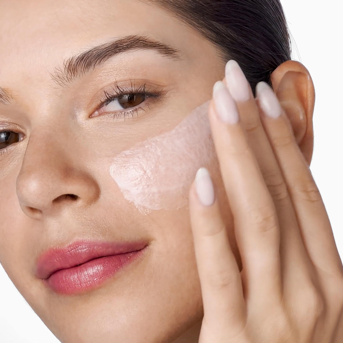 Clinique Moisture Surge jar in hand to show 3.4 fl oz scale and convenient size