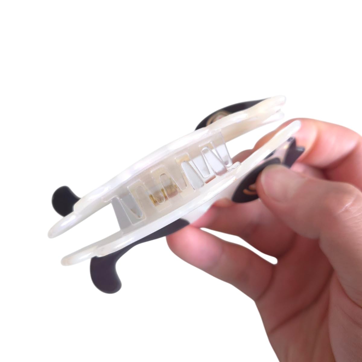 Clip Sugar held in hand for scale, compact size for travel convenience