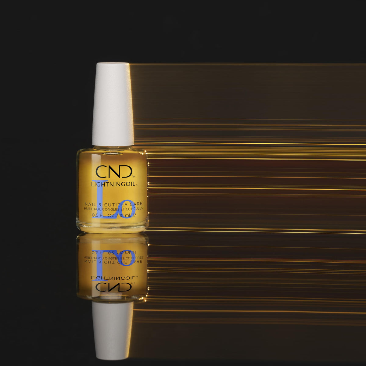 CND LIGHTNINGOIL bottle on vanity with citrus accents, conveys energizing scent benefit
