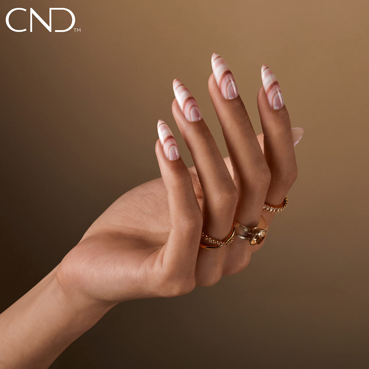 CND Romantique bottle beside coin showing 0.5 fl oz scale and travel-friendly benefit