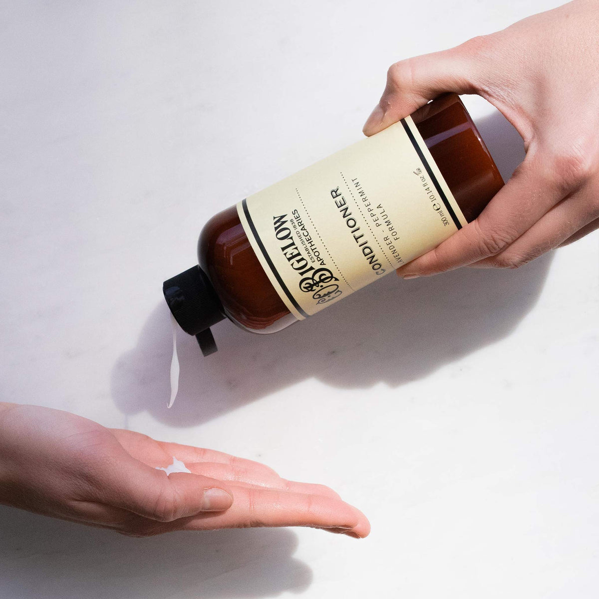 C.O. Bigelow pump dispensing conditioner into hand for easy application benefit