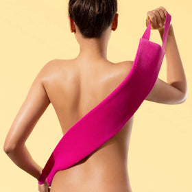 Coco & Eve applicator in use on a model’s back delivering smooth coverage