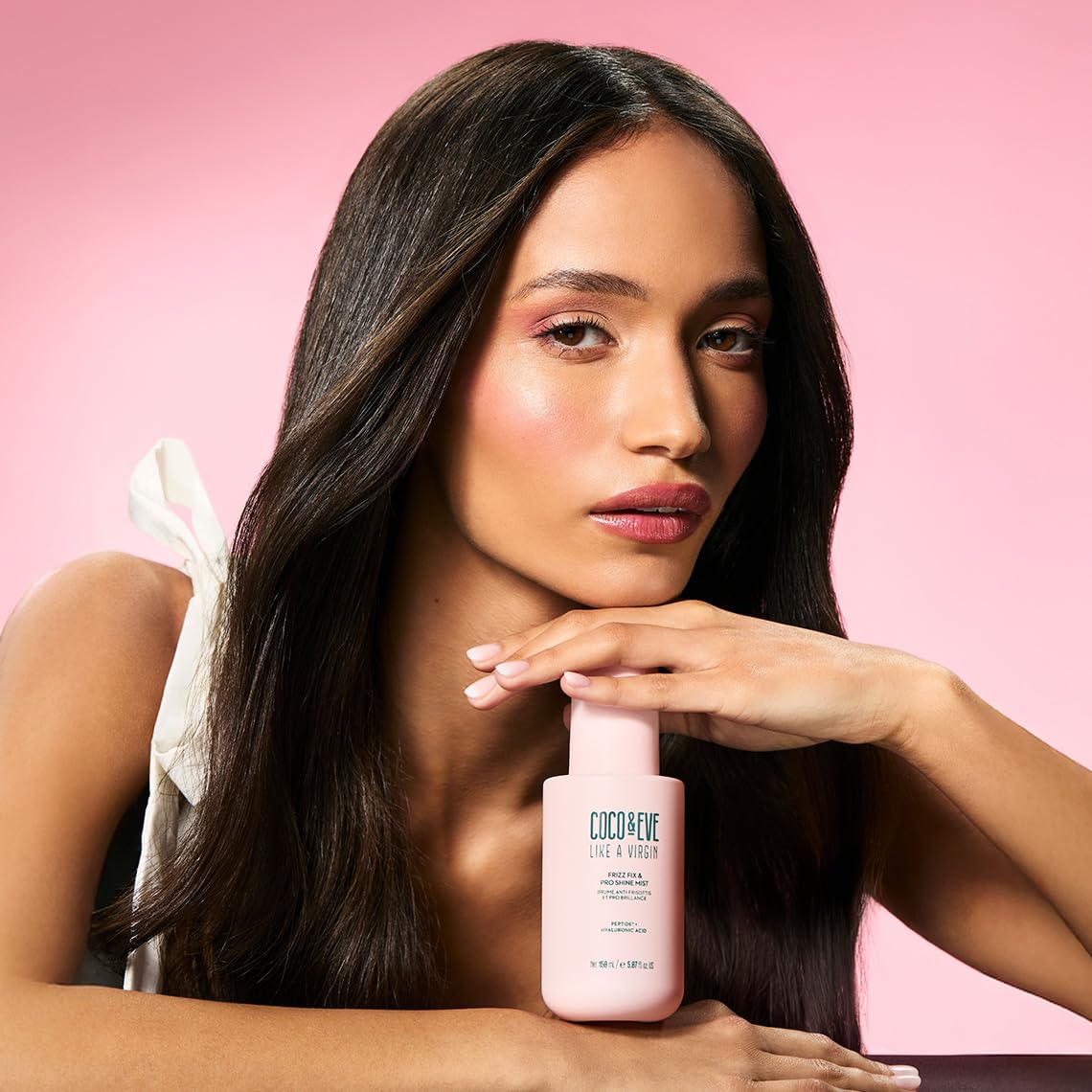 Coco & Eve bottle held in hand showing 5.07 fl oz travel-friendly benefit