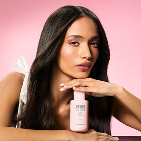 Coco & Eve bottle held in hand showing 5.07 fl oz travel-friendly benefit