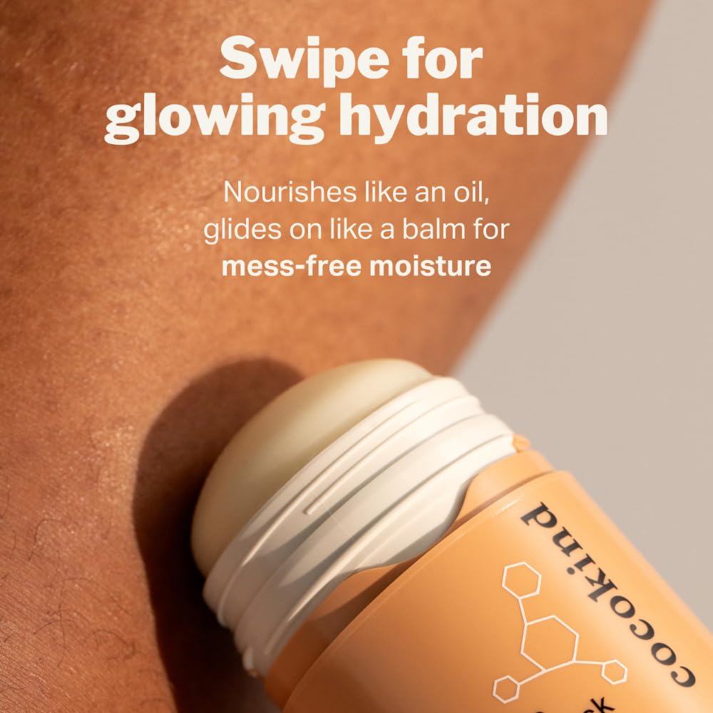 Cocokind stick in hand demonstrating scale and portable convenience for on-the-go moisturizing