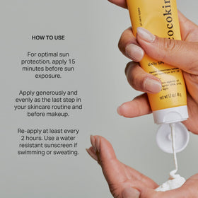 Cocokind applying sunscreen to hand demonstrating non-greasy feel