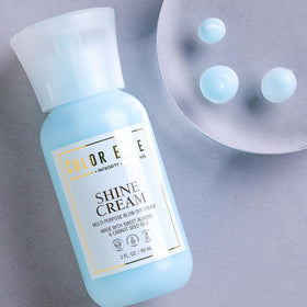Color Edge product in hand applying to damp hair to detangle and reduce dry time