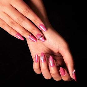 Top view of finished Color Street manicure showing hot-pink glitter and salon-quality shine