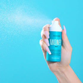 COLOR WOW bottle in hand showing size and convenience for travel and daily use