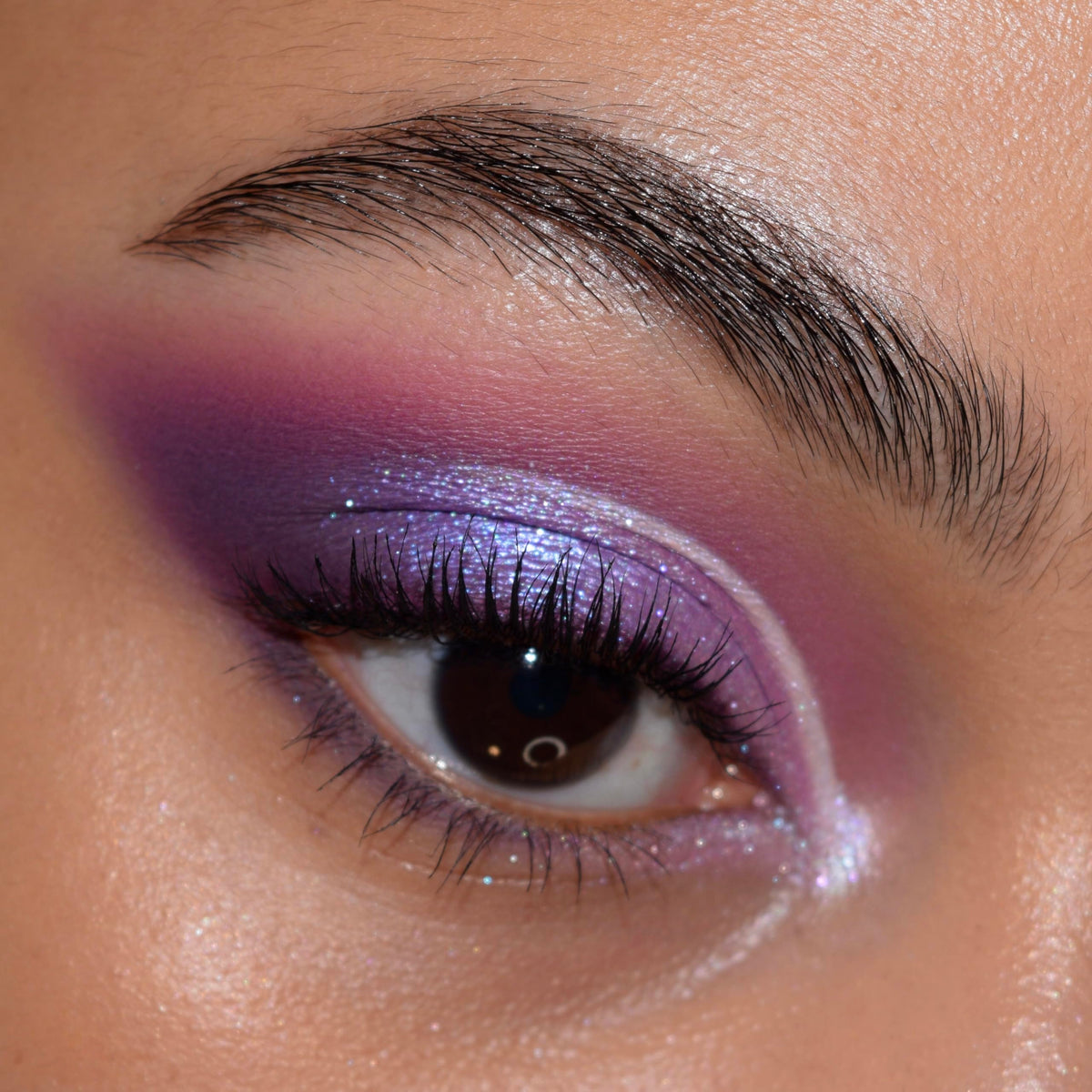ColourPop palette with brush applying color to lid demonstrating buildable payoff