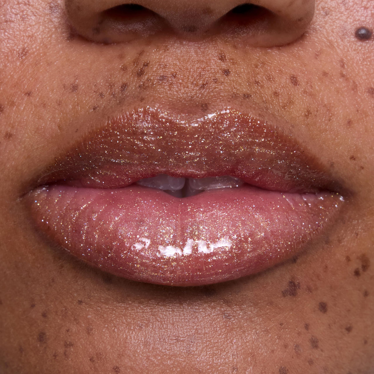 ColourPop Ambitious Tiana on lips of model offering luminous non-sticky hydration