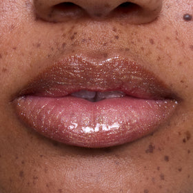 ColourPop Ambitious Tiana on lips of model offering luminous non-sticky hydration