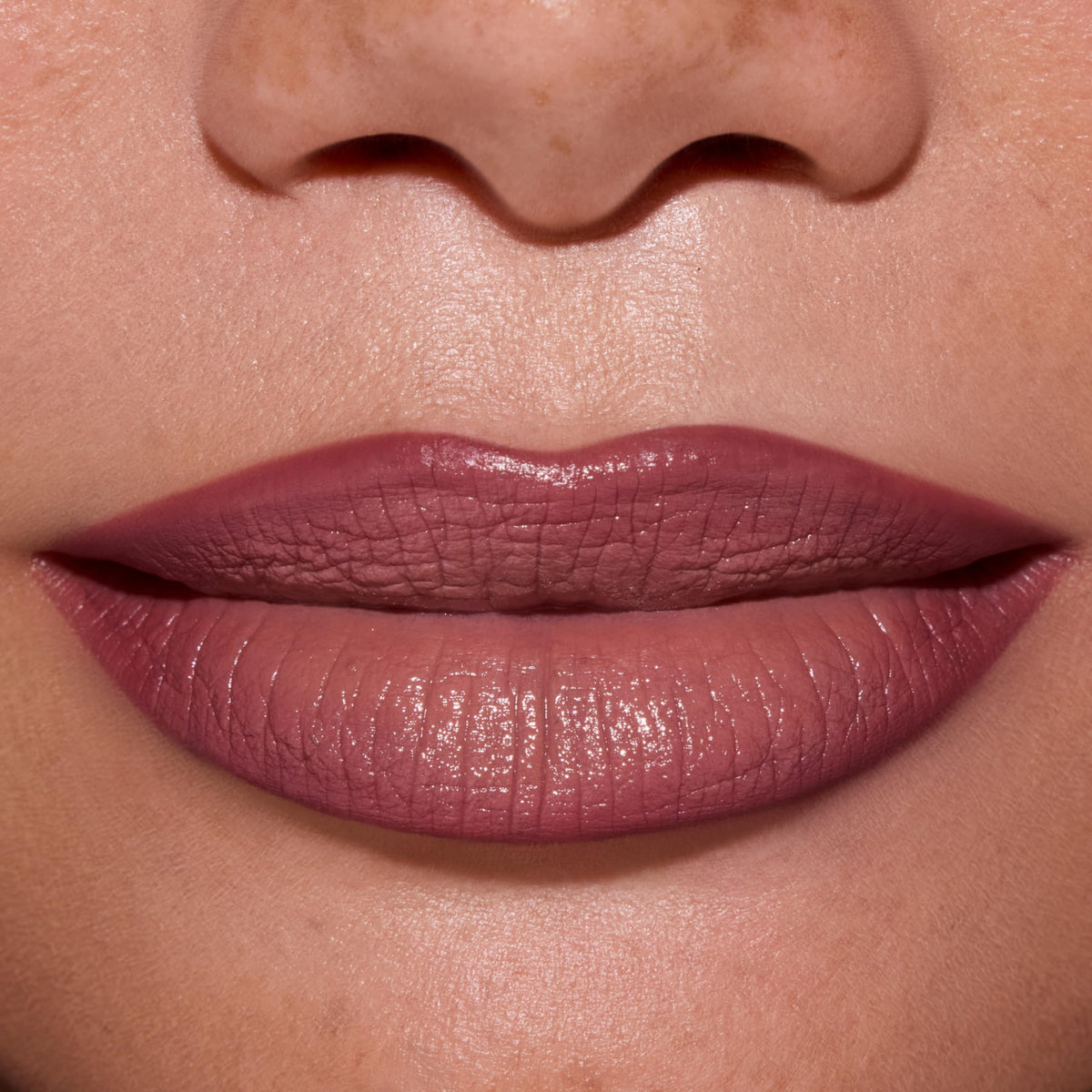ColourPop lip color worn on model in warm light demonstrating wearable pinky-nude shade